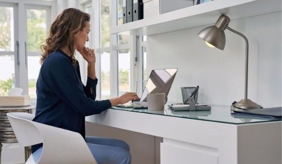 woman sat at desk on laptop