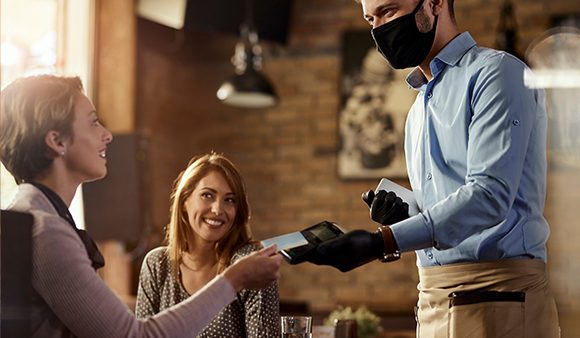 woman paying at a restaurant