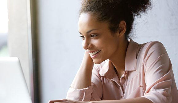 woman smiling at laptop