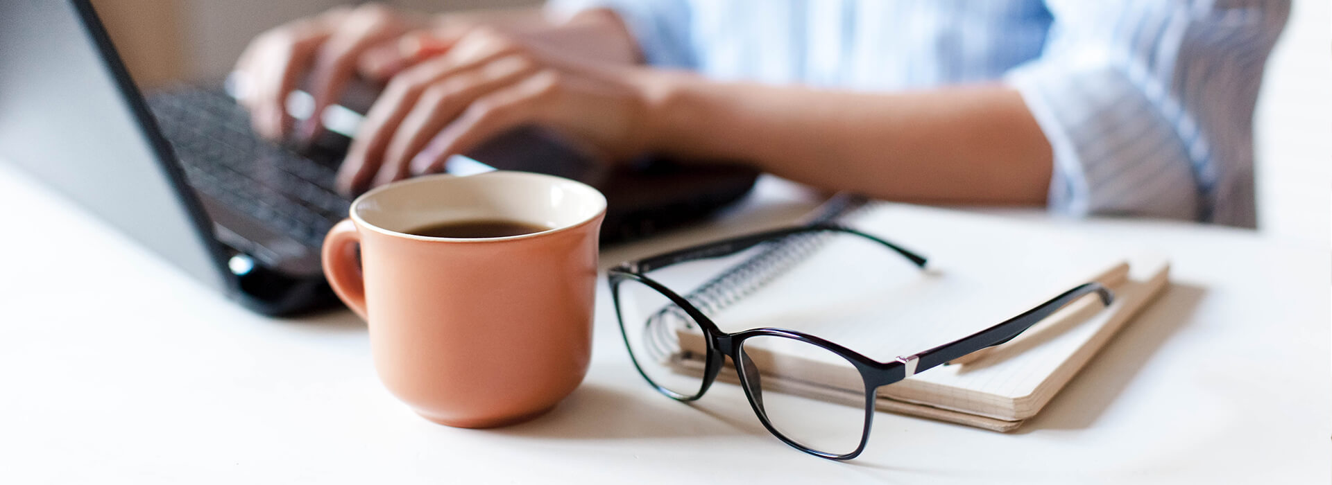 coffee mug and glasses on a desk