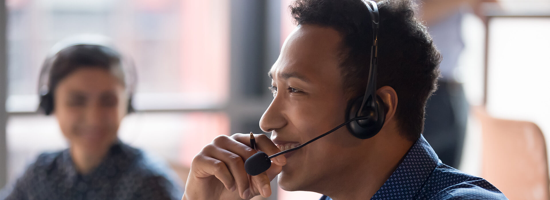 man with headset smiling