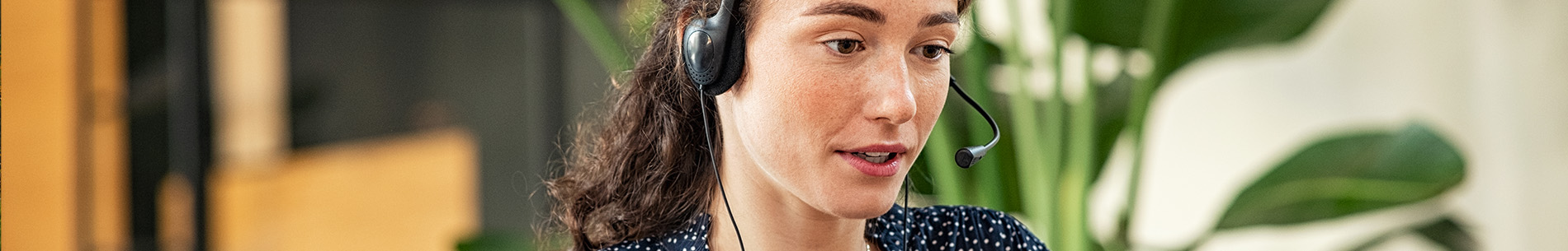 woman with headset on speaking banner