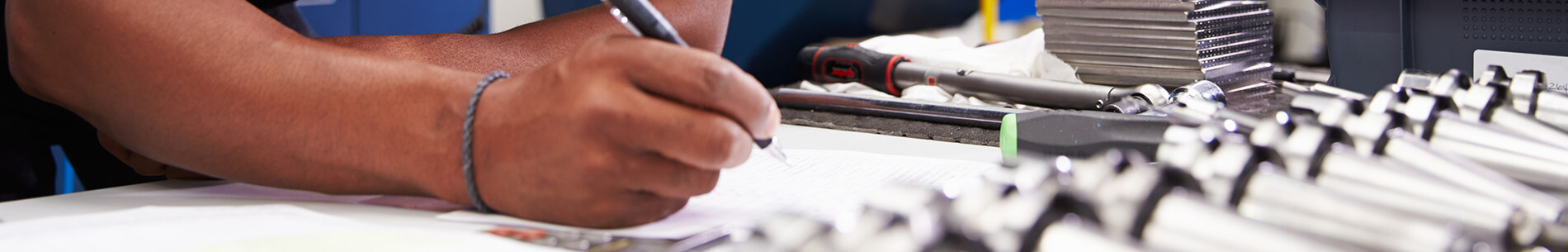 man writing with tools banner