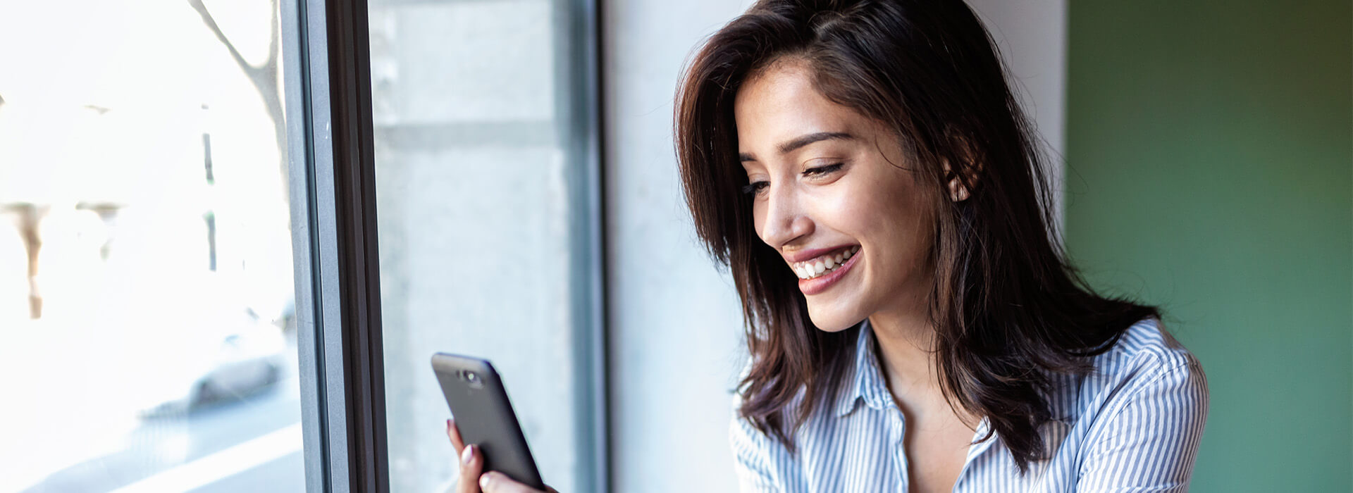 woman smiling at phone