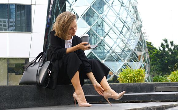 woman sat on stairs outside of an office