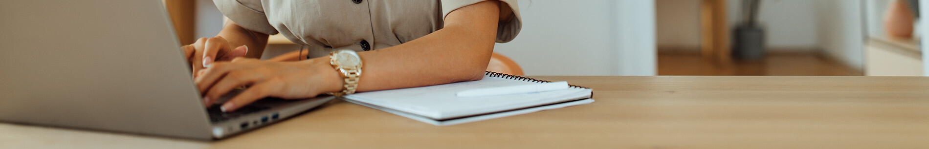 woman typing at laptop banner