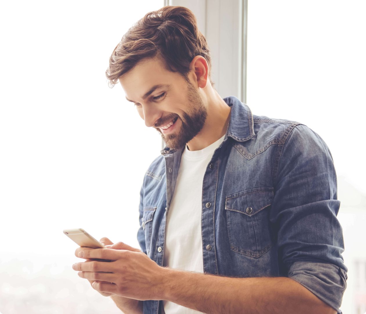 man standing smiling at phone