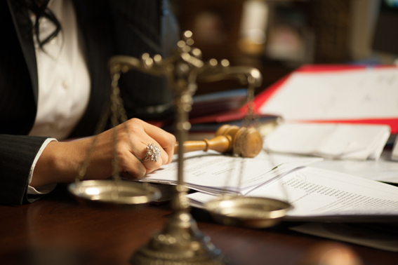female judge with a gavel and scales on her desk