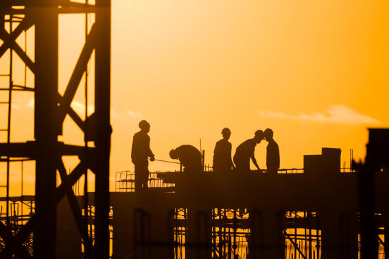 builders working with a sunset