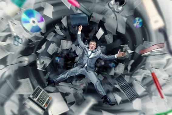 man falling into a tornado of office supplies