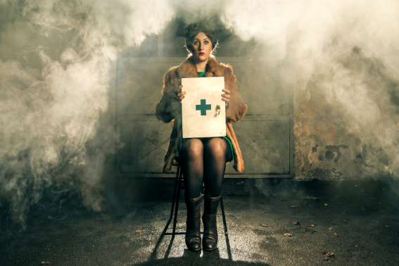 woman sat on stool holding first aid kit