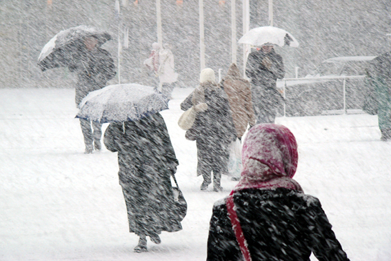people out walking in snowstorm