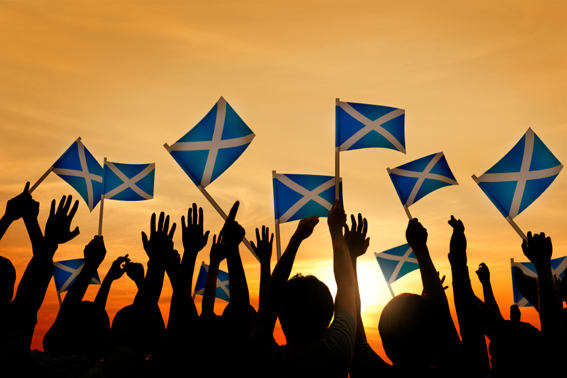 people waving scottish flags