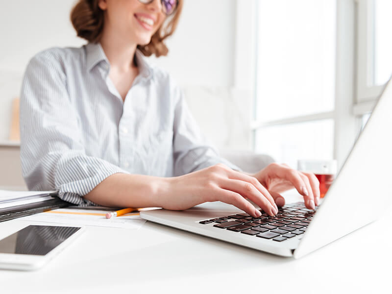 woman typing on laptop