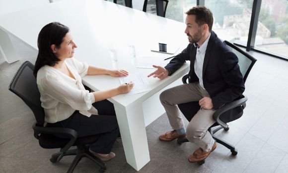 two people discussing at a table