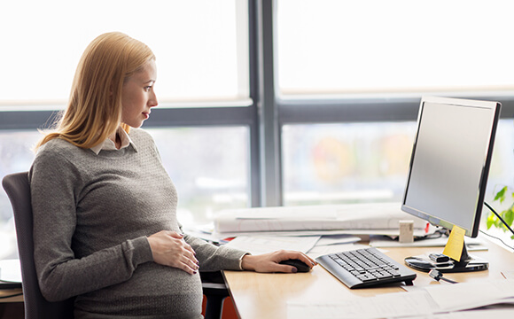 pregnant woman sat at desk working