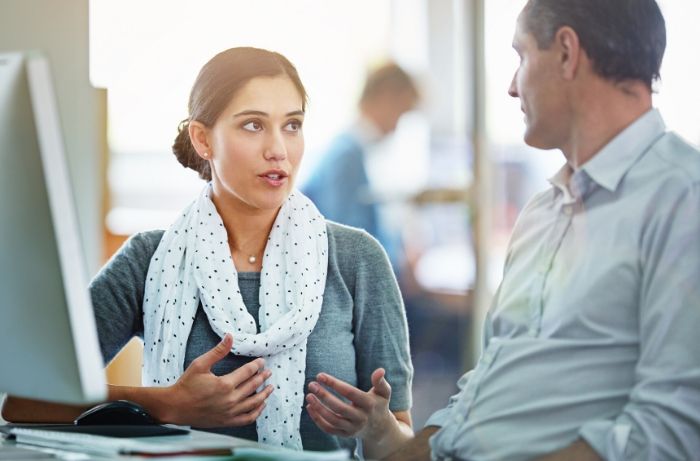 woman explaining something to coworker