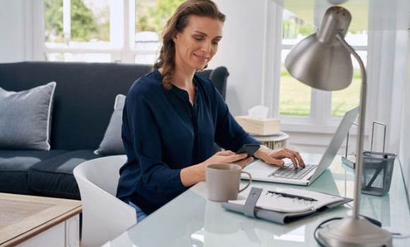 woman typing and looking at phone