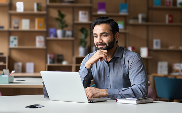 man thinking at laptop