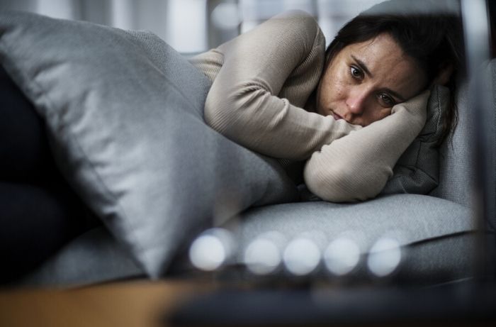 woman distressed in bed