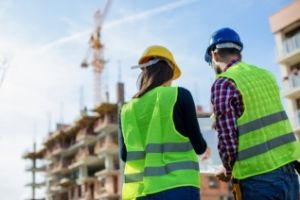 two workers in PPE on construction site