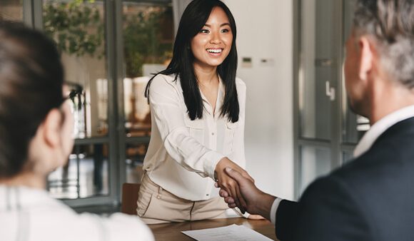 woman shaking hands with an interviewer