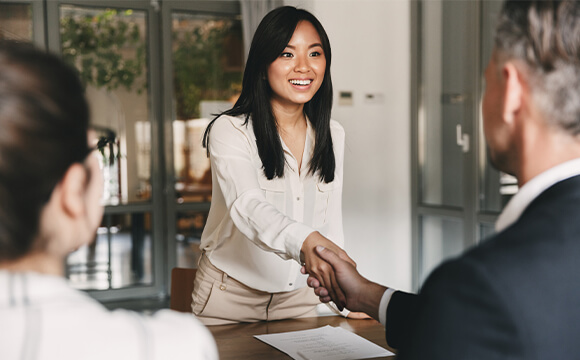 woman shaking hands with an interviewer