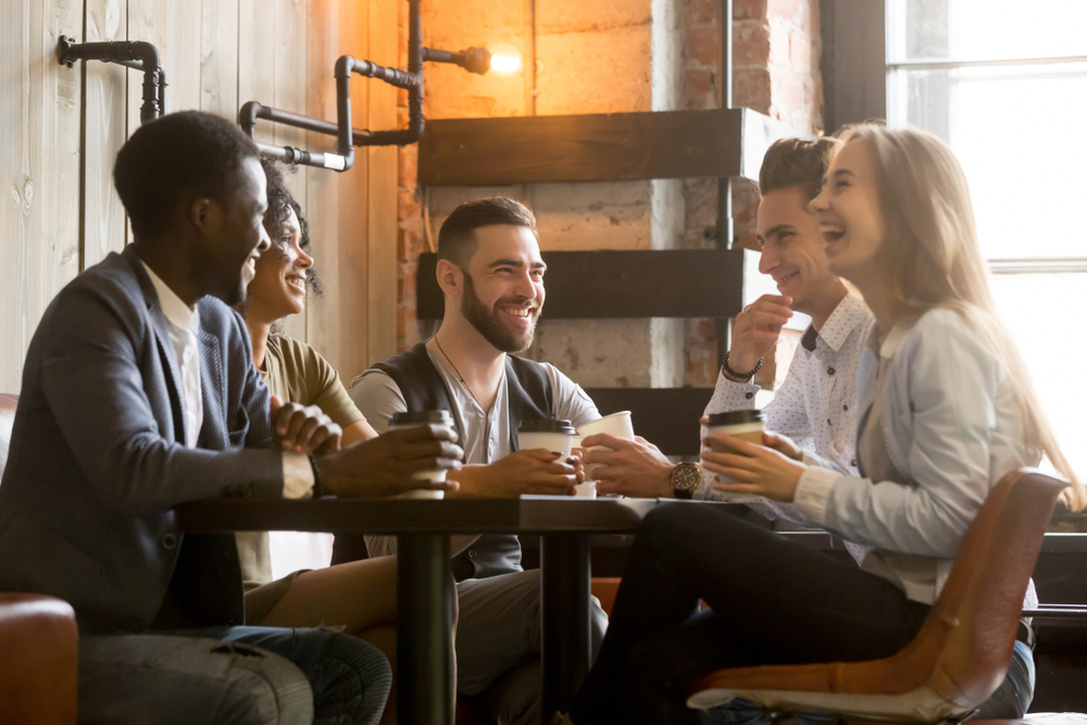 group of people laughing in a cafe