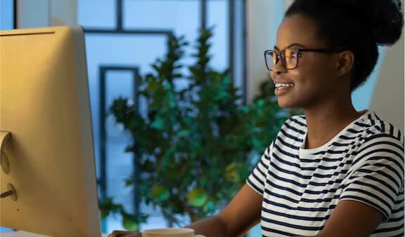 woman smiling at PC