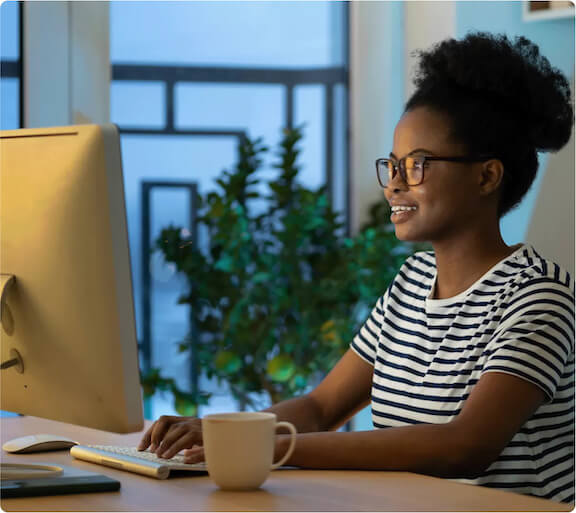 woman smiling at PC