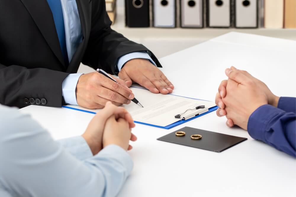 man with pen and clipboard on table in meeting