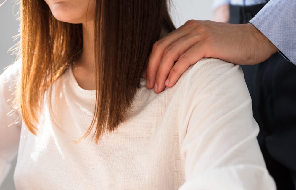 man grabbing woman in workplace