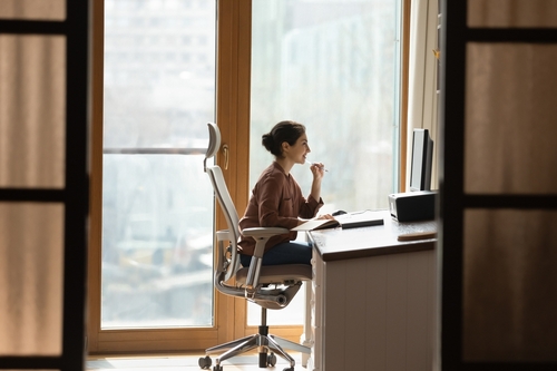 woman smiling at computer from far away