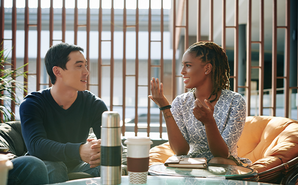 man and woman talking in a cafe