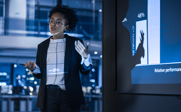 woman explaining in front of projector