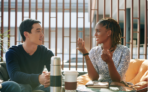 man and woman in cafe having a discussion