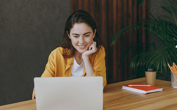 woman working on laptop smiling