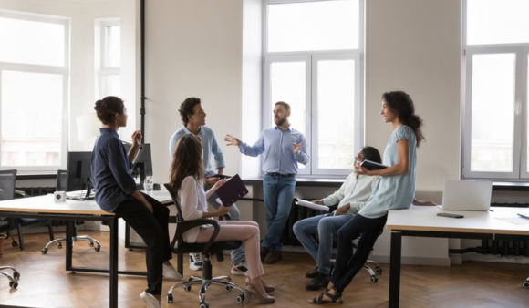 business team discussing standing in semi circle