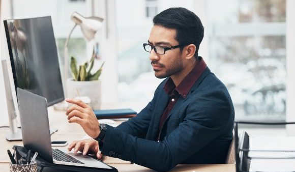 Laptop, administration and business man focus on finance spreadsheet, bank software or financial accounting. Bookkeeping account data, office gesture and consultant problem solving payroll system.